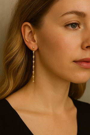 Gold dipped CZ chain dangle earrings, on ear