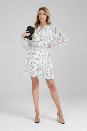Black and white polka dot mini dress with smocked waist and flared skirt