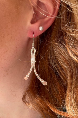 Textured silver metal earrings close up