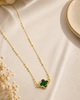 Gold dipped clover pendant with emerald rhinestones