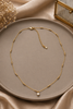Gold mini pave coin necklace, close-up detail
