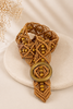 Brown macrame belt with intricate beadwork and wooden buckle