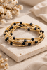 Mixed mini stone and metallic beaded bracelet set, styled on wrist