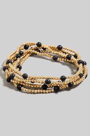 Stone and metallic beaded bracelets, flat lay view