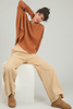 Black elastic-waist pants styled for casual weekend look
