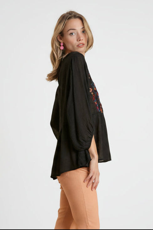 Embroidered peplum top with ruffled hemline and back keyhole