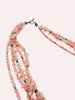 Coral and jade layered necklace detail