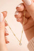 Delicate gold coin pendant chain necklace, styled view