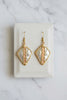 Gold and silver tone earrings close up