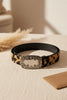 Faux leather cow print belt close up