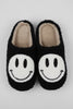 Fuzzy smiley face slippers pair