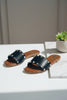 Gold stud black slipper close up