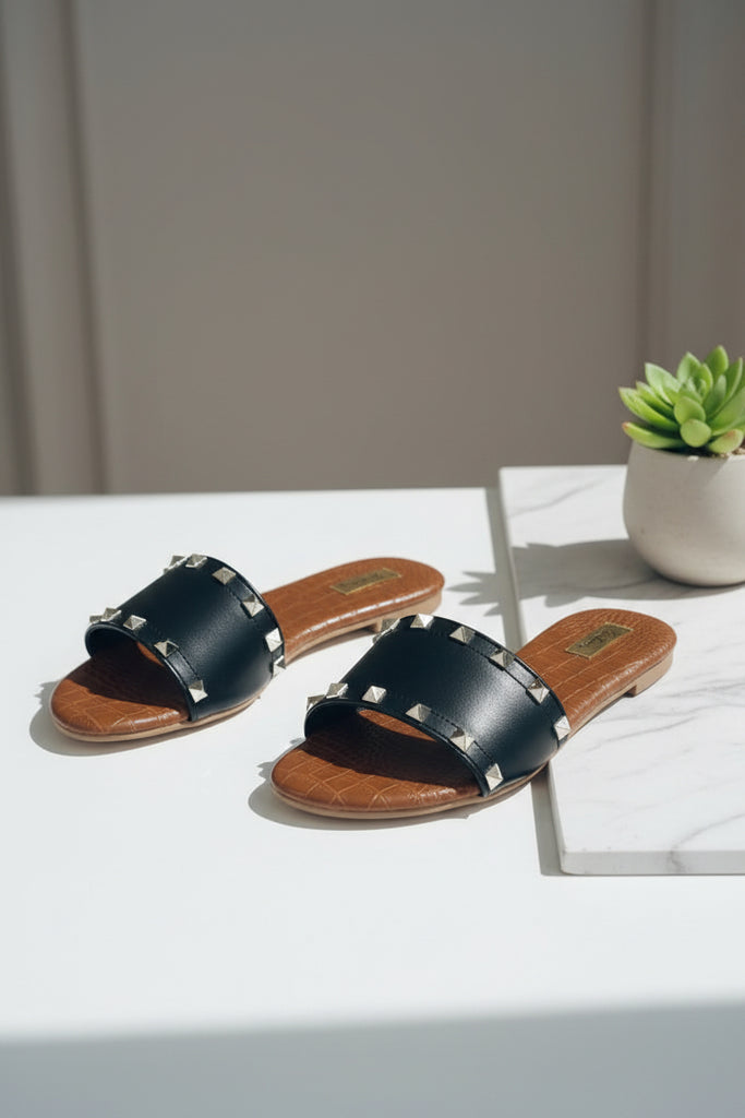 Gold stud black slipper close up