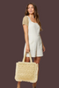 Sunlace straw tote with playful fringe accents, styled