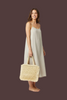Braided fringe straw tote bag, side view