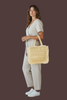 Straw tote bag with fringe detail showing spacious interior