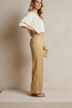 Golden cream wide-leg satin pants in fluid silhouette