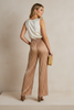 Golden cream satin pants close-up showing stripe detail