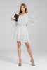Black and white polka dot mini dress with smocked waist and flared skirt
