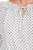 Smock-waist black and white polka dot mini dress styled for day to night