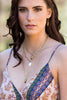 Layered gold sea shell necklace styled