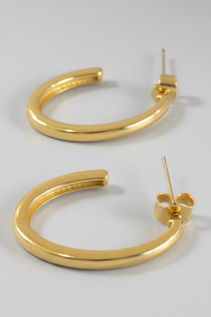 The arc gold dipped oval hoop earrings, on ear