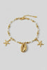 Gold anklet with shell charms close up
