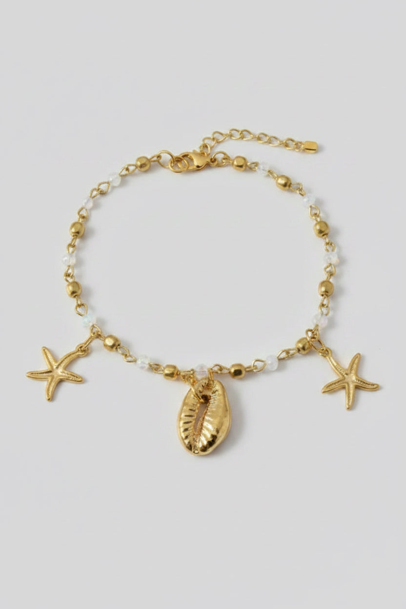 Gold anklet with shell charms close up