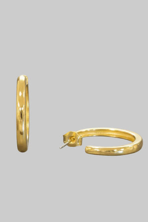 Gold oval hoop earrings, close-up detail