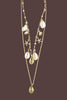 Gold sea shell layered necklace close up