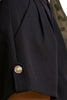 Pleated wide-leg shorts close-up showing button detail