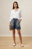 Indigo patchplay shorts with printed pockets, styled