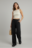 Wide-leg black pants with stretchy waistband, styled on model